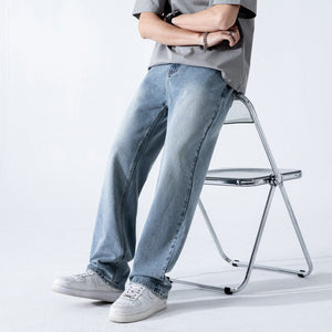 Light blue vintage men's jeans with a loose straight fit, washed wide-leg denim trousers, displayed on a plain background.