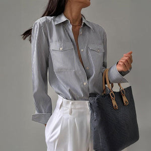 Women’s gray and white striped loose contrast cardigan, casual shirt with long sleeves and soft knit fabric.