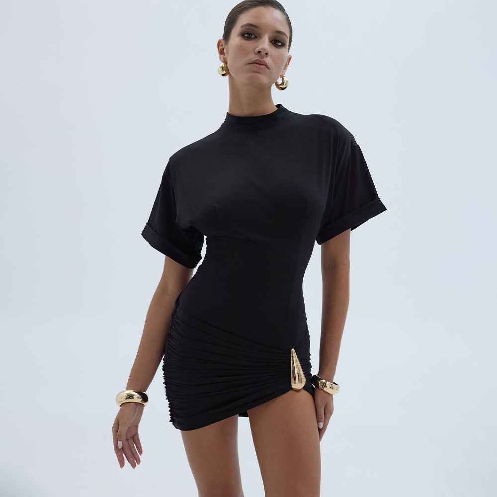MRC STORE crew-neck pleated high-waist sheath dress hanging on a mannequin showcasing elegant design and pleated fabric.