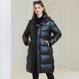 Long Hooded Winter Coat - MRC STOREJacketsMRC STOREA woman wearing a long black hooded winter coat with full - length sleeves and standing in a light - colored space.MRC STORECJWJ217303803CXBlackL