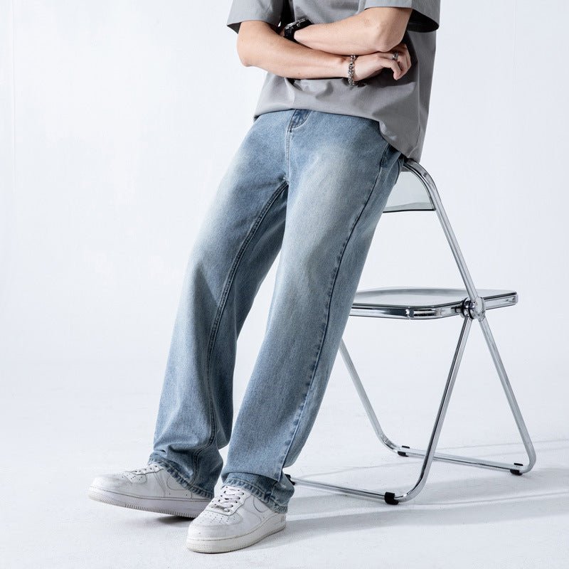 Light blue vintage men's jeans with a loose straight fit, washed wide-leg denim trousers, displayed on a plain background.