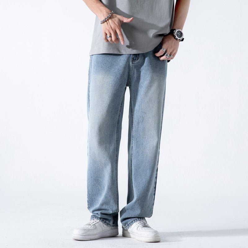 Light blue vintage men's jeans with a loose straight fit, washed finish, wide leg style, made from denim fabric.