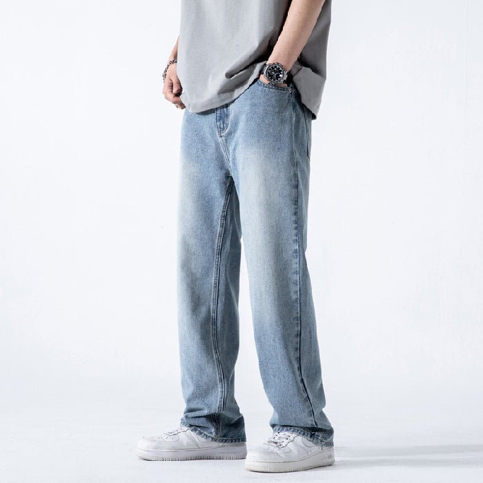 Light blue vintage men's jeans with loose straight fit, washed wide-leg denim trousers, displayed on a hanger.