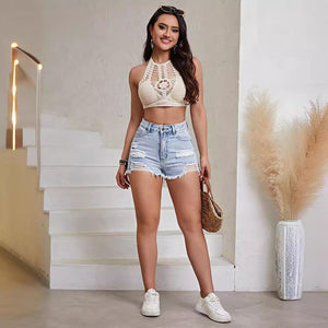 Light blue distressed denim shorts with a relaxed fit, featuring frayed hems and trendy style, perfect for casual wear.